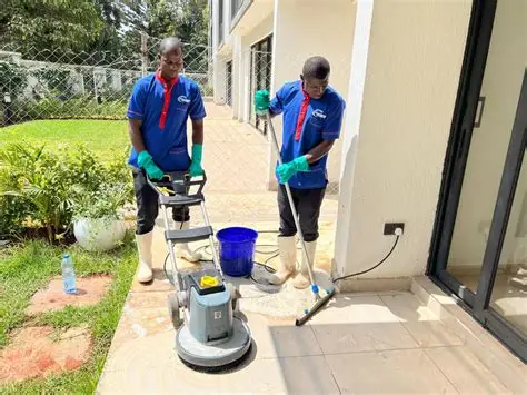 Oseko Solutions cleaners using professional floor-cleaning equipment outside a Nairobi property